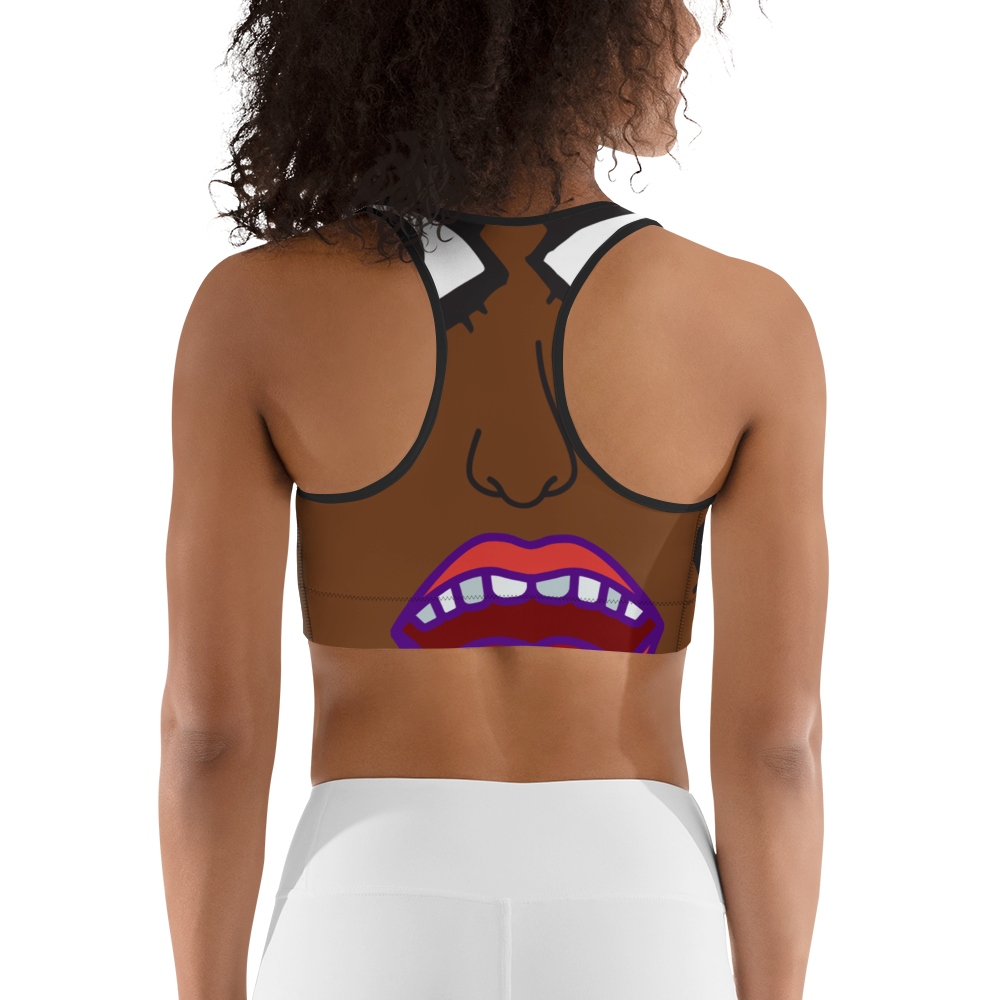 The back of this sports bra is brown with a nose that's slightly off-center, with half of an open mouth below the nose. The lips are red, and there are a row of teeth. The sports bra appears artsy and surreal, with the illusion there is a face on the back of the wearer of the bra.