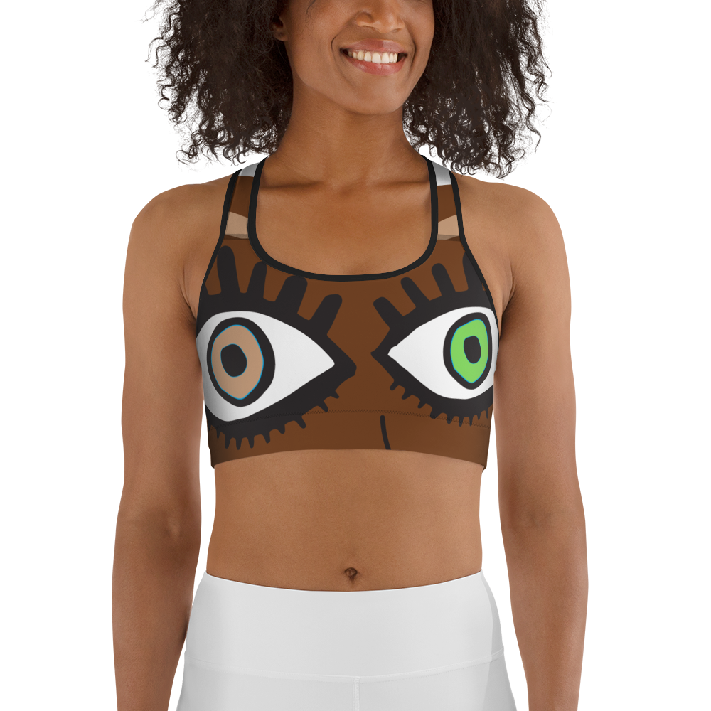 This is a sports bra with a brown print base, covered with two eyes. Each eye is a slightly different size, one eye is green and the other is a light brown. The drawing style of the eyes is bold and pop art inspired. The eyes are placed over where breasts might be, in a fun, playful way that explores the idea of confronting gaze with gaze.